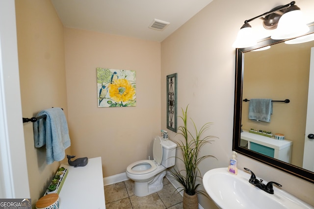 108 Hope Ln, Cedartown, GA 30125 - bathroom with toilet, a sink, visible vents, tile patterned flooring, and baseboards
