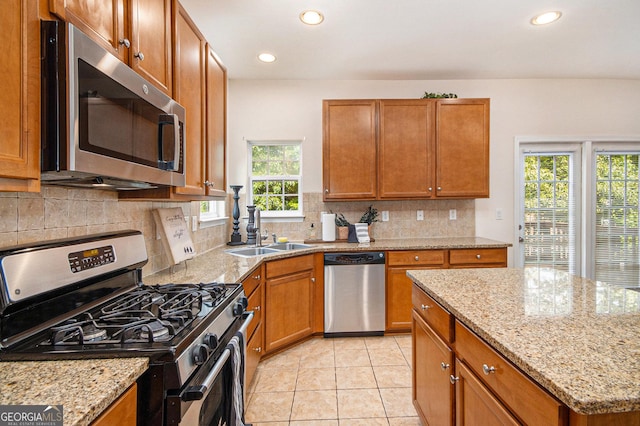 kitchen with brown cabinets, stainless steel appliances, and recessed lighting