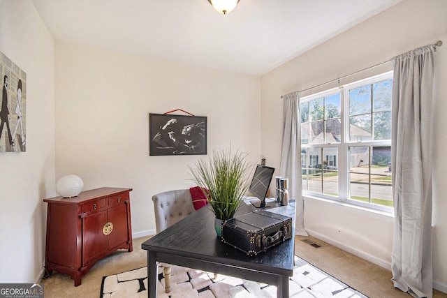 office area with visible vents, light carpet, and plenty of natural light