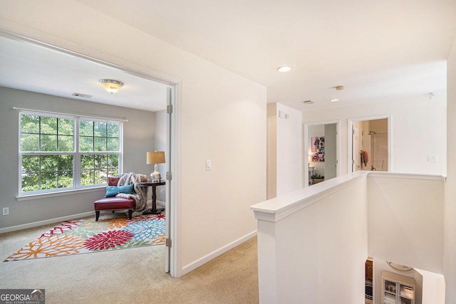 hallway with visible vents, light colored carpet, baseboards, an upstairs landing, and recessed lighting