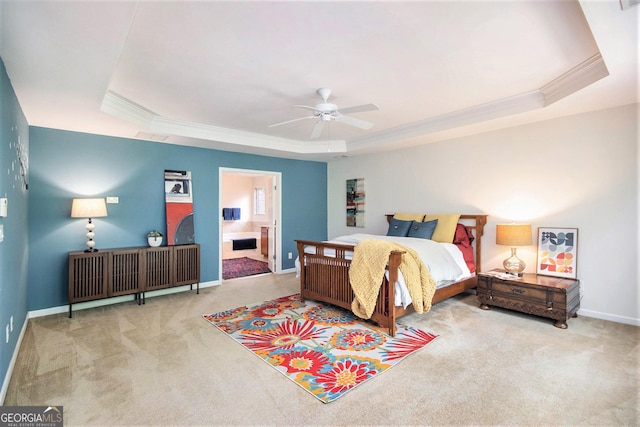 bedroom featuring a raised ceiling, ornamental molding, baseboards, and carpet floors