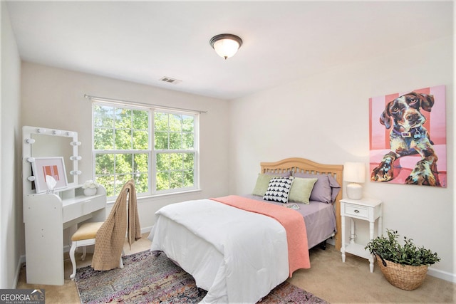 carpeted bedroom with baseboards and visible vents