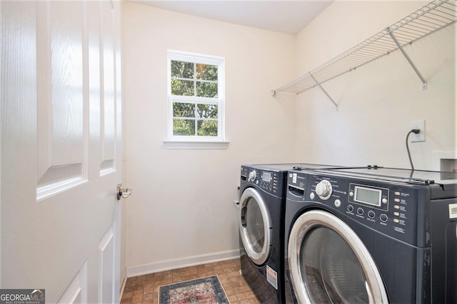 laundry room with baseboards, laundry area, and independent washer and dryer