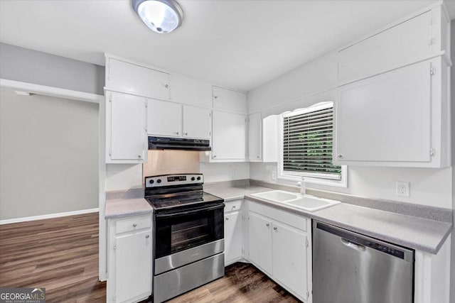 kitchen with white cabinets, stainless steel appliances, a sink, and light countertops