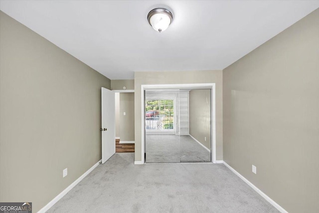 interior space with carpet floors, baseboards, and a closet