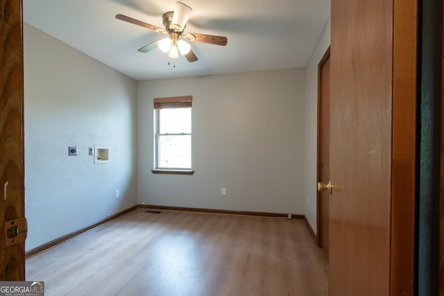 empty room with light wood-style floors, baseboards, and ceiling fan