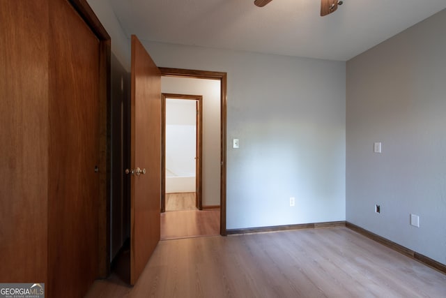 unfurnished bedroom with baseboards, ceiling fan, and light wood-style flooring