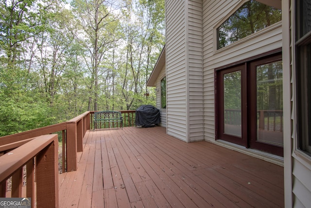 wooden terrace featuring a grill