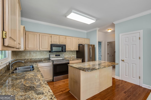 4481 Mccart Cv, Stone Mountain, GA 30083 - kitchen featuring appliances with stainless steel finishes, a sink, light brown cabinetry, a center island, and backsplash
