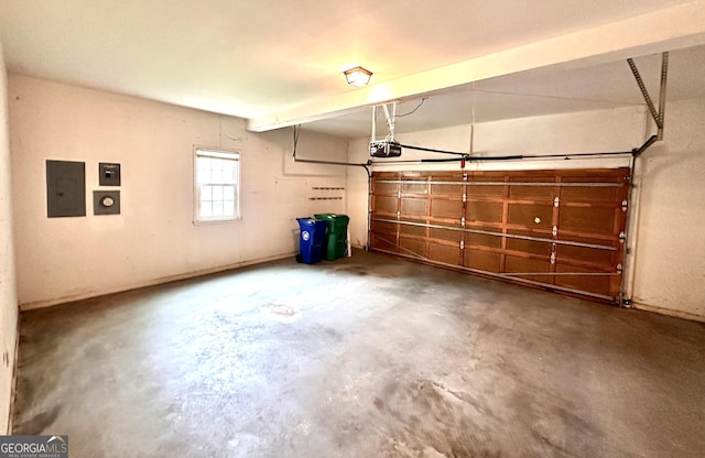 garage with a garage door opener and electric panel