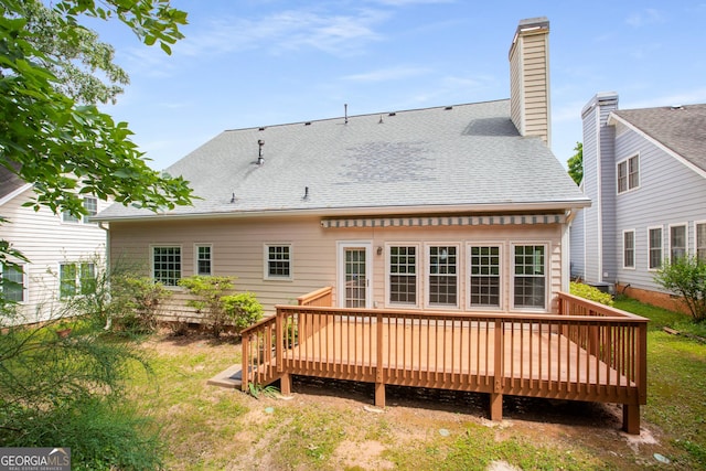 4481 Mccart Cv, Stone Mountain, GA 30083 - rear view of house with a wooden deck, roof with shingles, and a chimney