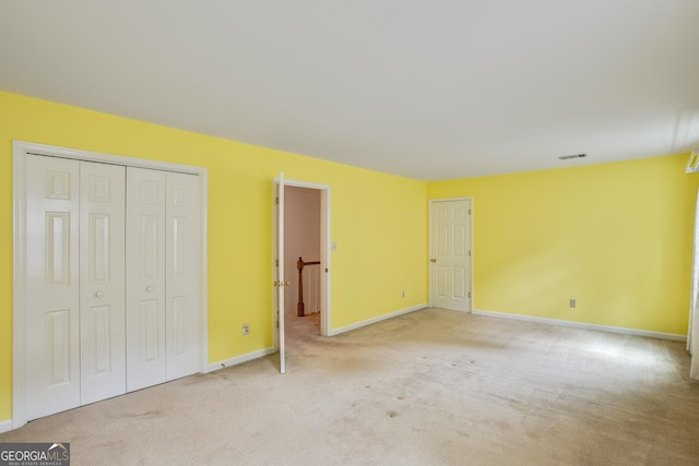 4481 Mccart Cv, Stone Mountain, GA 30083 - unfurnished bedroom featuring light carpet and baseboards
