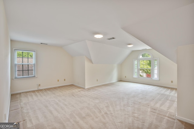 4481 Mccart Cv, Stone Mountain, GA 30083 - additional living space with plenty of natural light, light colored carpet, baseboards, and lofted ceiling