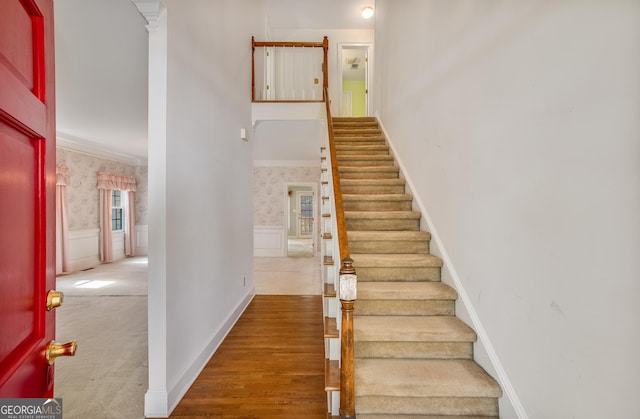 4481 Mccart Cv, Stone Mountain, GA 30083 - stairway with wainscoting, wallpapered walls, and ornamental molding