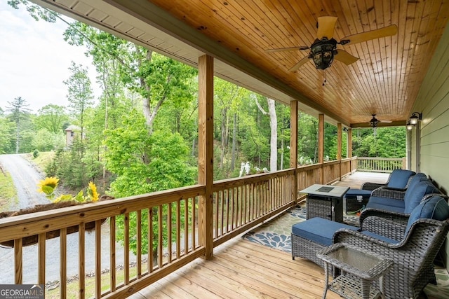 wooden terrace featuring ceiling fan