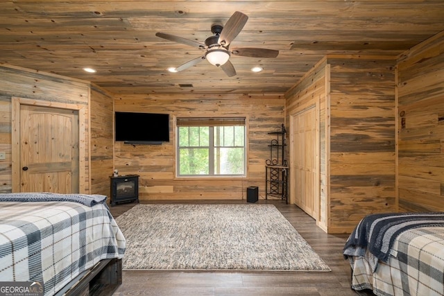 bedroom featuring wood ceiling, a wood stove, dark wood-style floors, wooden walls, and recessed lighting