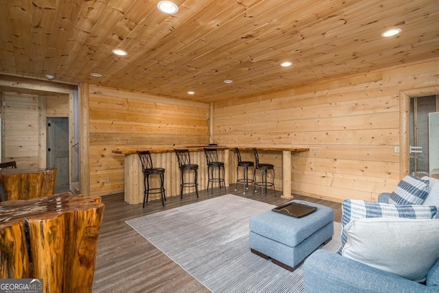 living room with wood walls, wood ceiling, recessed lighting, and wood finished floors