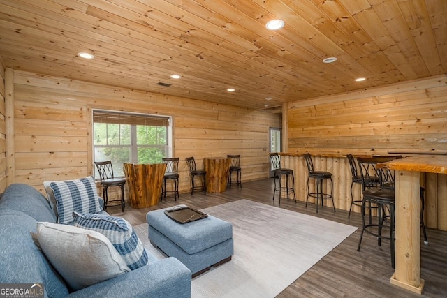 living room featuring recessed lighting, wood ceiling, wood finished floors, and wooden walls