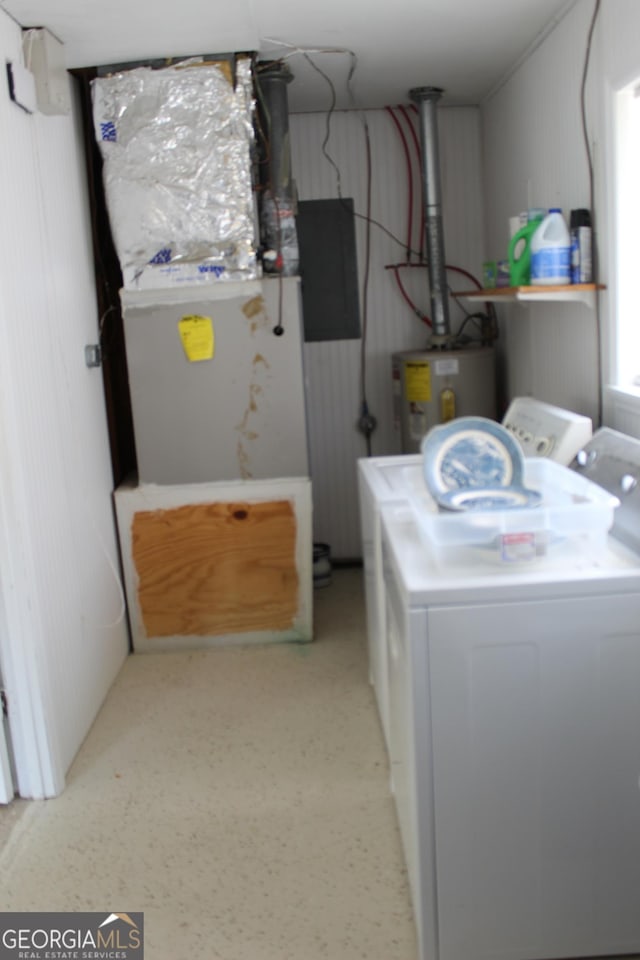 clothes washing area with washer / clothes dryer, laundry area, and electric water heater