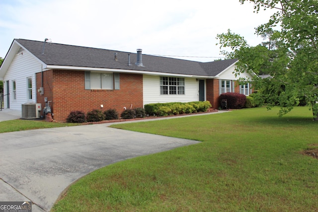 ranch-style home with brick siding, central AC, and a front yard