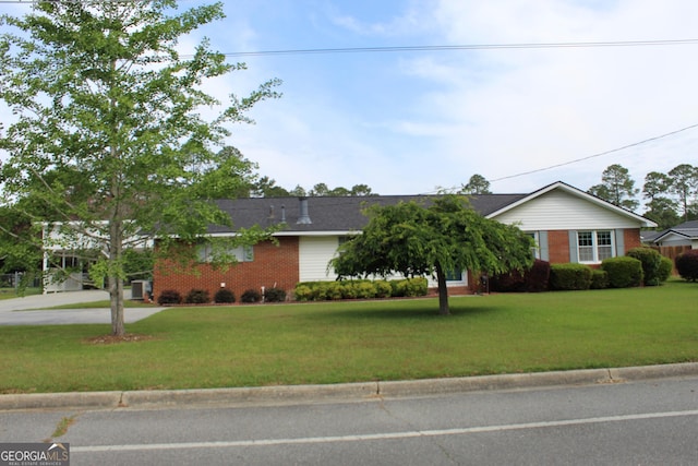 single story home with brick siding, driveway, and a front yard