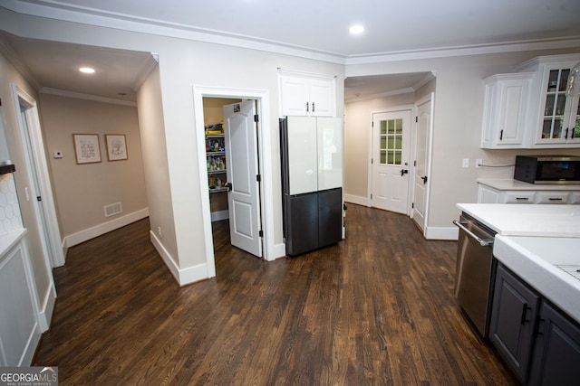 kitchen featuring visible vents, ornamental molding, light countertops, white cabinetry, and stainless steel appliances