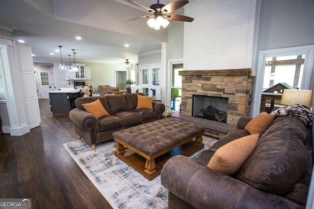 living room featuring recessed lighting, a fireplace, a ceiling fan, and dark wood-style flooring