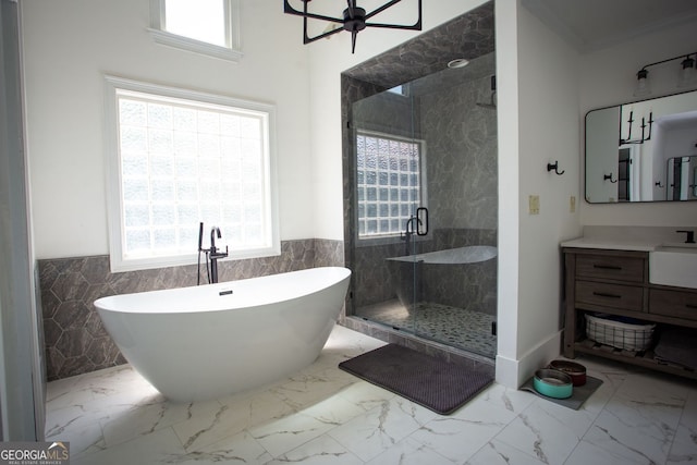 full bathroom with tile walls, a wainscoted wall, and a stall shower
