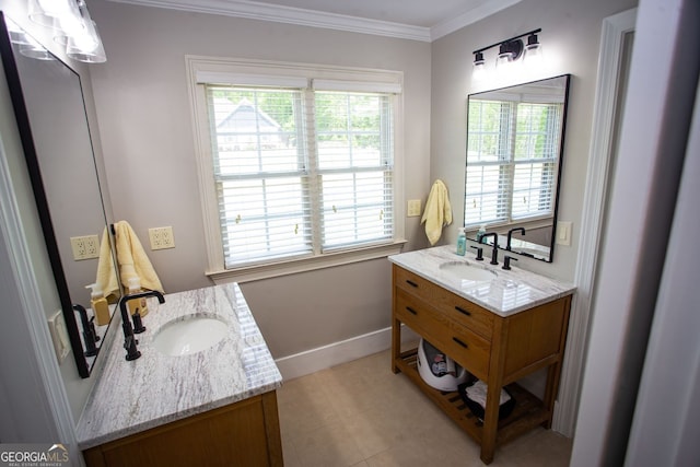 bathroom featuring crown molding, baseboards, two vanities, and a sink