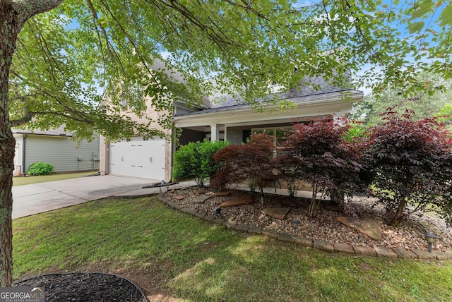 view of property hidden behind natural elements featuring concrete driveway, a porch, and a front yard