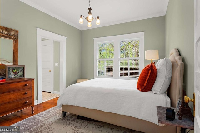 171 Westminster Dr NE, Atlanta, GA 30309 - bedroom featuring wood finished floors, crown molding, a chandelier, and baseboards