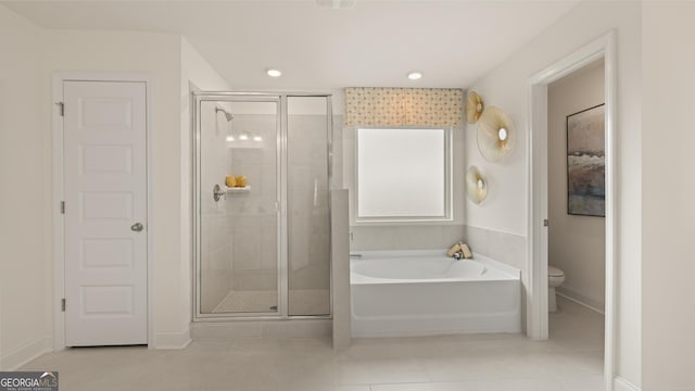 bathroom featuring a garden tub, tile patterned flooring, a stall shower, baseboards, and toilet
