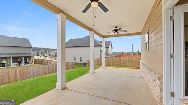 view of patio / terrace featuring a residential view, ceiling fan, and a fenced backyard