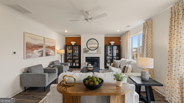 living room with baseboards, dark wood-style flooring, ceiling fan, and visible vents