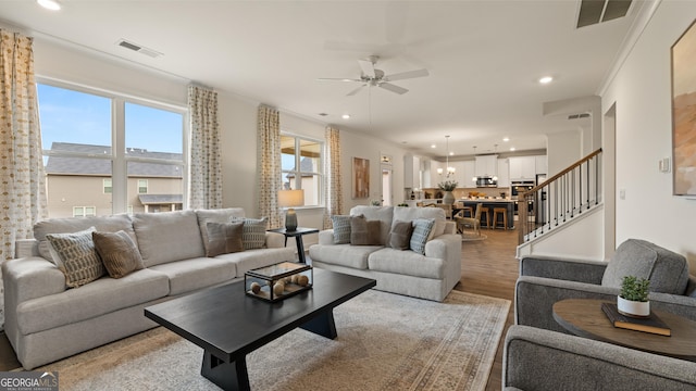 living room featuring a ceiling fan, recessed lighting, light wood-style flooring, and visible vents
