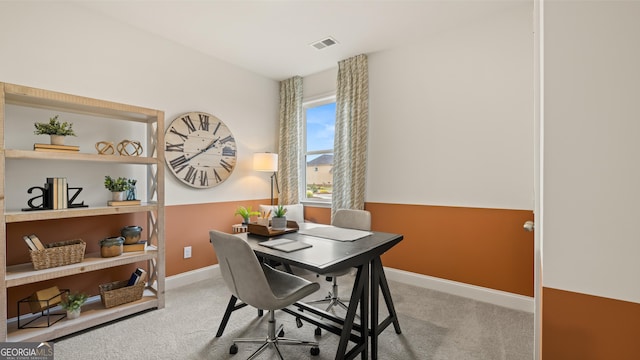 carpeted home office with visible vents and baseboards