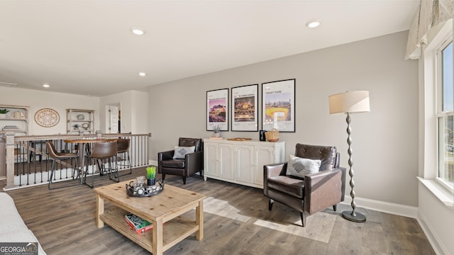 living area featuring recessed lighting, baseboards, and wood finished floors
