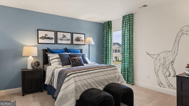 bedroom featuring baseboards, light carpet, and visible vents