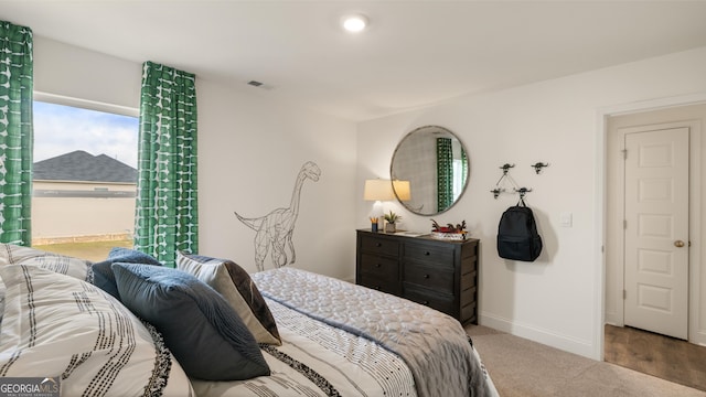bedroom featuring baseboards and visible vents
