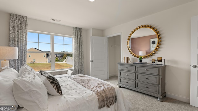 bedroom with light colored carpet, baseboards, and visible vents