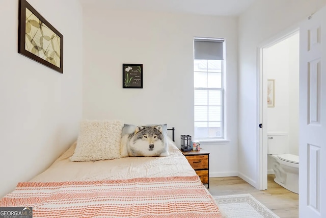 1418 2nd Ave, Macon, GA 31201 - bedroom with light wood-style flooring, ensuite bath, and baseboards