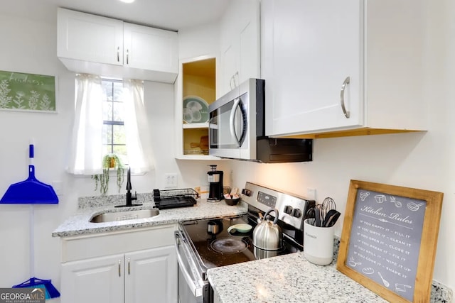 1418 2nd Ave, Macon, GA 31201 - kitchen with white cabinets, stainless steel appliances, light stone counters, and a sink