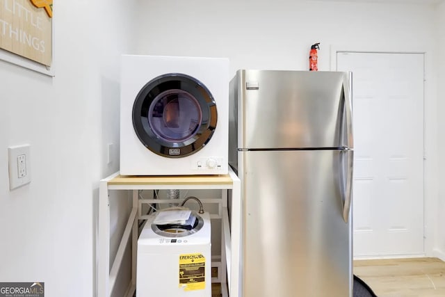 1418 2nd Ave, Macon, GA 31201 - laundry room featuring stacked washer and dryer, laundry area, and wood finished floors