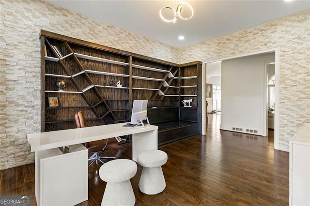unfurnished office featuring visible vents and wood finished floors