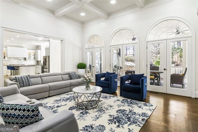 living area with coffered ceiling, beamed ceiling, french doors, and dark wood-type flooring
