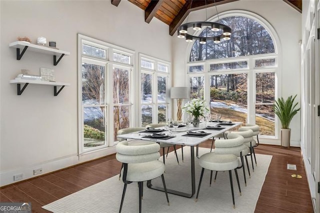 sunroom featuring french doors, beamed ceiling, a chandelier, and a healthy amount of sunlight