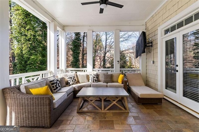 sunroom / solarium with a ceiling fan, outdoor lounge area, and french doors