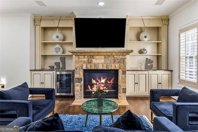 living area with crown molding, dark wood-style flooring, and wine cooler