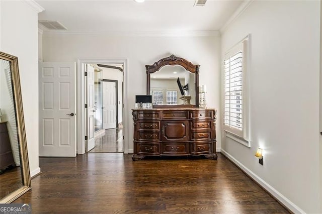 bedroom with baseboards, ornamental molding, dark wood-style floors, and visible vents