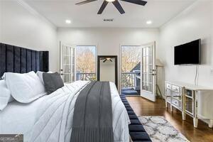 bedroom featuring recessed lighting, multiple windows, access to outside, and wood finished floors